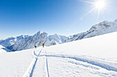 skier in deep powder snow, Zugspitze, overlooking Reintal Valley and Hochwanner, Upper Bavaria, Germany