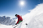 freeride skier jumps over snow cornice, Zugspitze, overlooking and Hochwanner, Upper Bavaria, Germany