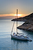 Anchoring sailing yacht in a lonely bay on the greek island Syphnos (Sifnos), Aegean, Cyclades, Greece
