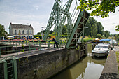 Le Boat Royal Mystique houseboat passing a drawbridge on the river Leie, near Deinze, Flemish Region, Belgium