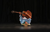 Boy playing the guitar upside down, Villa Escudero, Manila, Philippines, Asia