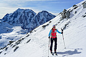 Woman back-country skiing ascending towards Schrammacher, Hochferner in background, Schrammacher, valley of Pfitsch, Zillertal Alps, South Tyrol, Italy