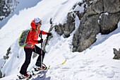 Woman back-country skiing ascending towards Scharnitzsattel, Scharnitzsattel, Lechtal Alps, Tyrol, Austria