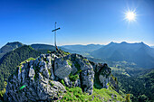 Person sitting at summit of Leonhardstein, view to Tegernsee Mountains, Leonhardstein, Bavarian Alps, Upper Bavaria, Bavaria, Germany
