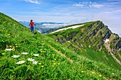 Woman hiking ascending to Rindalphorn, Rindalphorn, Nagelfluh range, Allgaeu Alps, Allgaeu, Svabia, Bavaria, Germany