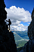 Woman doing fixed rope route Masare, Masare, Rotwand, Rosengarten, UNESCO world heritage Dolomites, Dolomites, Trentino, Italy