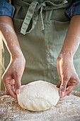 Mixed race woman kneading dough, Jersey City, New Jersey, USA