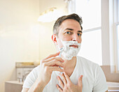 Caucasian man shaving in bathroom, Lehi, Utah, USA