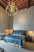 Chandelier over bed in modern hotel room, Guanajuato, Guanajuato, Mexico