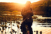 Mari fisherman preparing hook in lake , C1