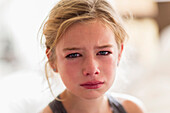 Close up of red face of crying Caucasian girl, Moab, Utah, USA