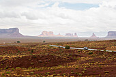 Rock formations and remote road in desert landscape, Monument Valley, Utah, USA
