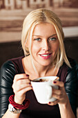 Woman drinking cup of coffee, Pancevo, Serbia, Serbia