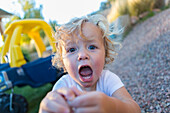 Caucasian boy shouting in backyard, Santa Fe, New Mexico, USA