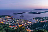 Aerial view of coastal town illuminated at night, Hvar, Split, Croatia