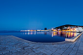 Waterfront sidewalk, illuminated boats and dock at dusk, Split, Split, Croatia, Split, Split, Croatia