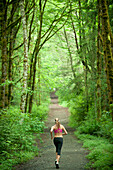 Caucasian woman running on remote path, Bainbridge Island, Wa, USA
