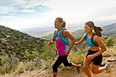 Hispanic women running in remote area, Albuquerque, New Mexico, USA