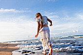Caucasian girl walking on beach, Kauai, Hawaii, USA