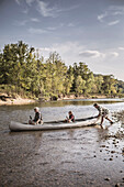 Three generations of Caucasian men in canoe on river, Saint Louis, Missouri, USA