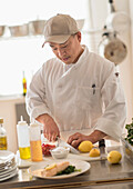 Korean chef slicing food in kitchen, Jersey City, New Jersey, USA