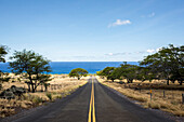 Empty road leading to ocean, The Big Island, Hawaii, United States