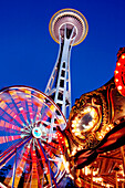 Low angle view of Space Needle, ferris wheel and carousel under night sky, Seattle, Washington, United States, Seattle, WA, United States