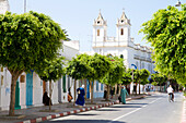 Morocco, Asilah, street scene, Saint Bartholomew church in backgound
