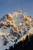 France, Midi Pyrennes, Hautes Pyrenees, Evening light on the Pic du Midi de Bigorre and its observatory viewed from the north face in winter