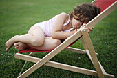 Portait of a 4 years old girl on a lounge chair for child