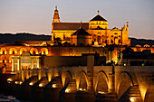 Roman bridge and Mezquita in Cordoba, Andalusia at dusk. Spain.