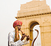 Asian snake charmer playing flute