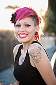 Smiling, tattooed Hispanic woman