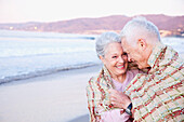 Senior Caucasian couple standing on beach