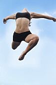 Mixed race girl jumping in air