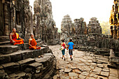 Couple visiting Buddhist temple, Angkor, Siem Reap, Cambodia