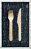 Wooden fork and knife on chalkboard