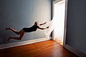 Levitating Woman Holding Curtains