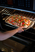 Pizza Being Put in Oven