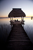 People relaxing at sunset, Lago Peten Itza, El Remate, Guatemala, Central America