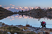 A panoramic view of the Alpine range overlooking the Mont Avic Natural Parc reflecting in a small lake in the Aosta Valley, Italy, Europe