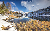 The Brenta Dolomites covered in snow reflecting in the Lake Malghette, Trentino, Italy, Europe