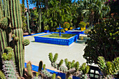 Blue fountain and cactus in the Majorelle Gardens (Gardens of Yves Saint-Laurent), Marrakech, Morocco, North Africa, Africa