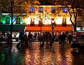 Restaurants and cafes lit at night in the Montmartre area of Paris, France, Europe