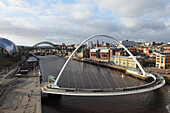 Millennium Bridge and Tyne Bridge span the River Tyne, from Gateshead to Newcastle, Tyne and Wear, England, United Kingdom, Europe