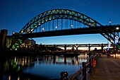 Gateshead Quays with Tyne Bridge and River Tyne swing bridge at night, Tyne and Wear, England, United Kingdom, Europe