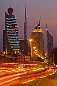 City skyline and car trail lights at sunset, Dubai, United Arab Emirates, Middle East