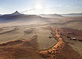 Aerial view from hot air balloon at dawn over magnificent desert landscape of sand dunes, mountains and Fairy Circles, Namib Rand game reserve Namib Naukluft Park, Namibia, Africa
