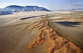 Aerial view from hot air balloon over magnificent desert landscape of sand dunes, mountains and Fairy Circles, Namib Rand game reserve Namib Naukluft Park, Namibia, Africa