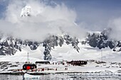 Snow-capped mountains surround Port Lockroy, Antarctica, Southern Ocean, Polar Regions